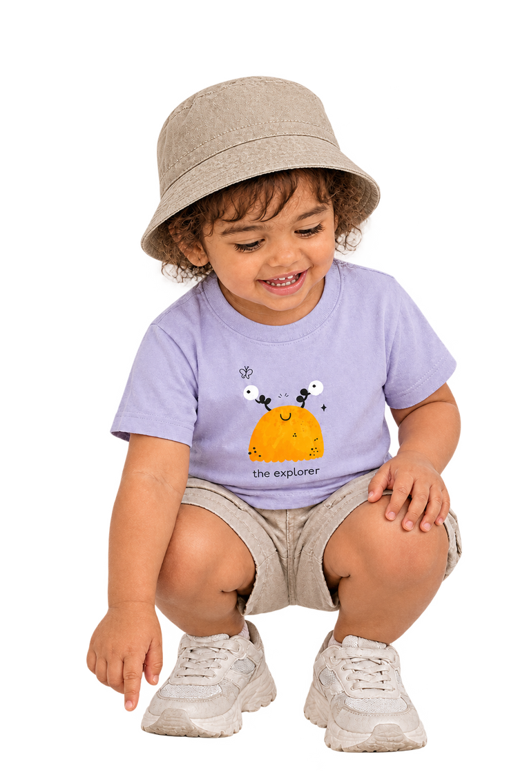 Anaya crouching in The explorer tee, hat over crown
