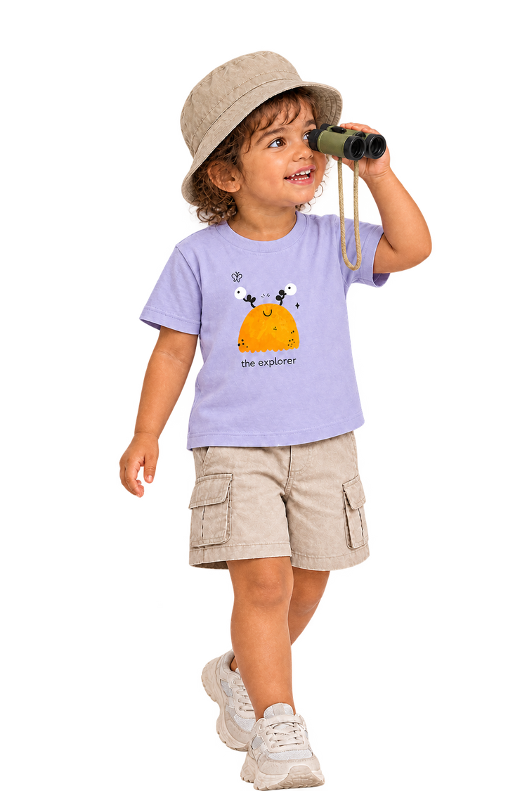 Anaya with binoculars in The explorer tee, hat over crown