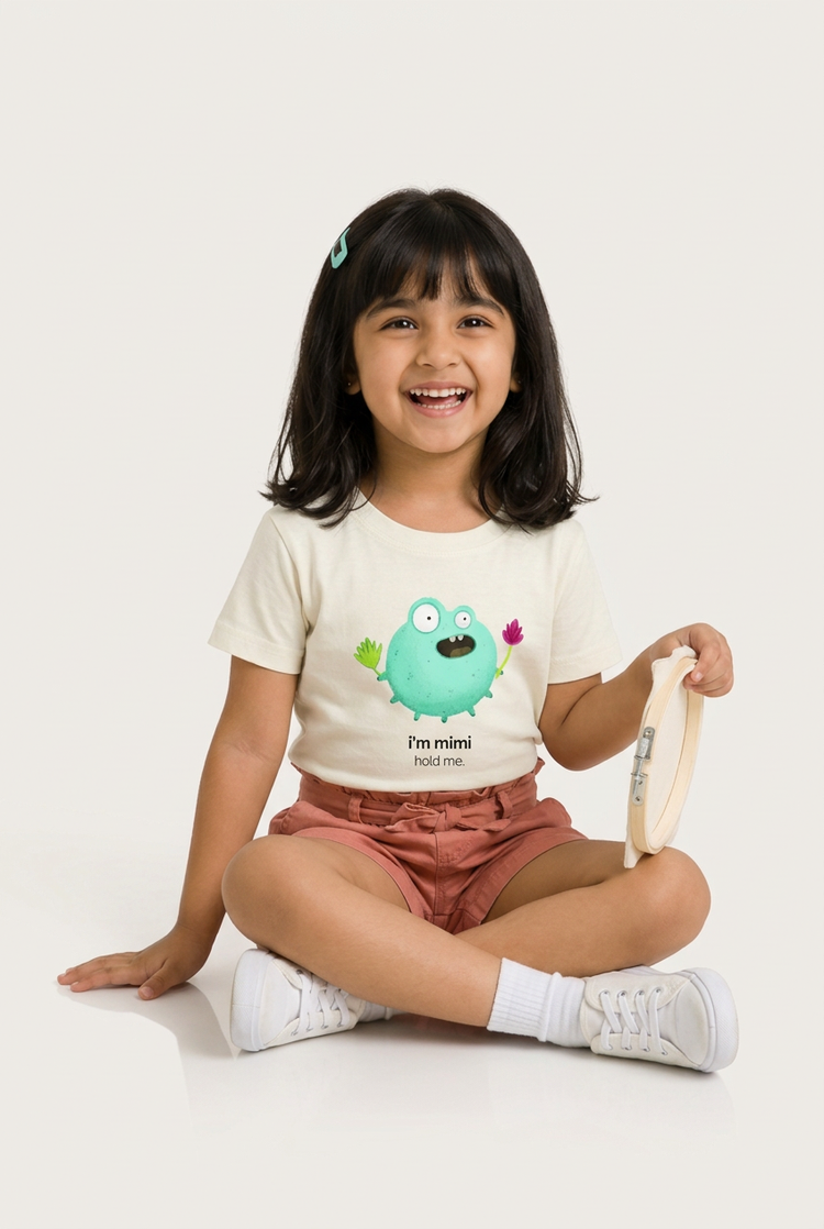 Tara in Mimi tee, playful seated pose